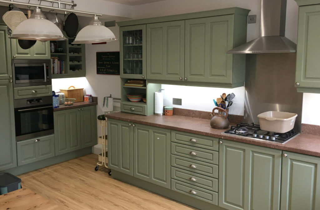 Transformed kitchen in Maidstone, Kent featuring resprayed cabinets, drawers, plinths, and cornices in Farrow and Ball Lichen.